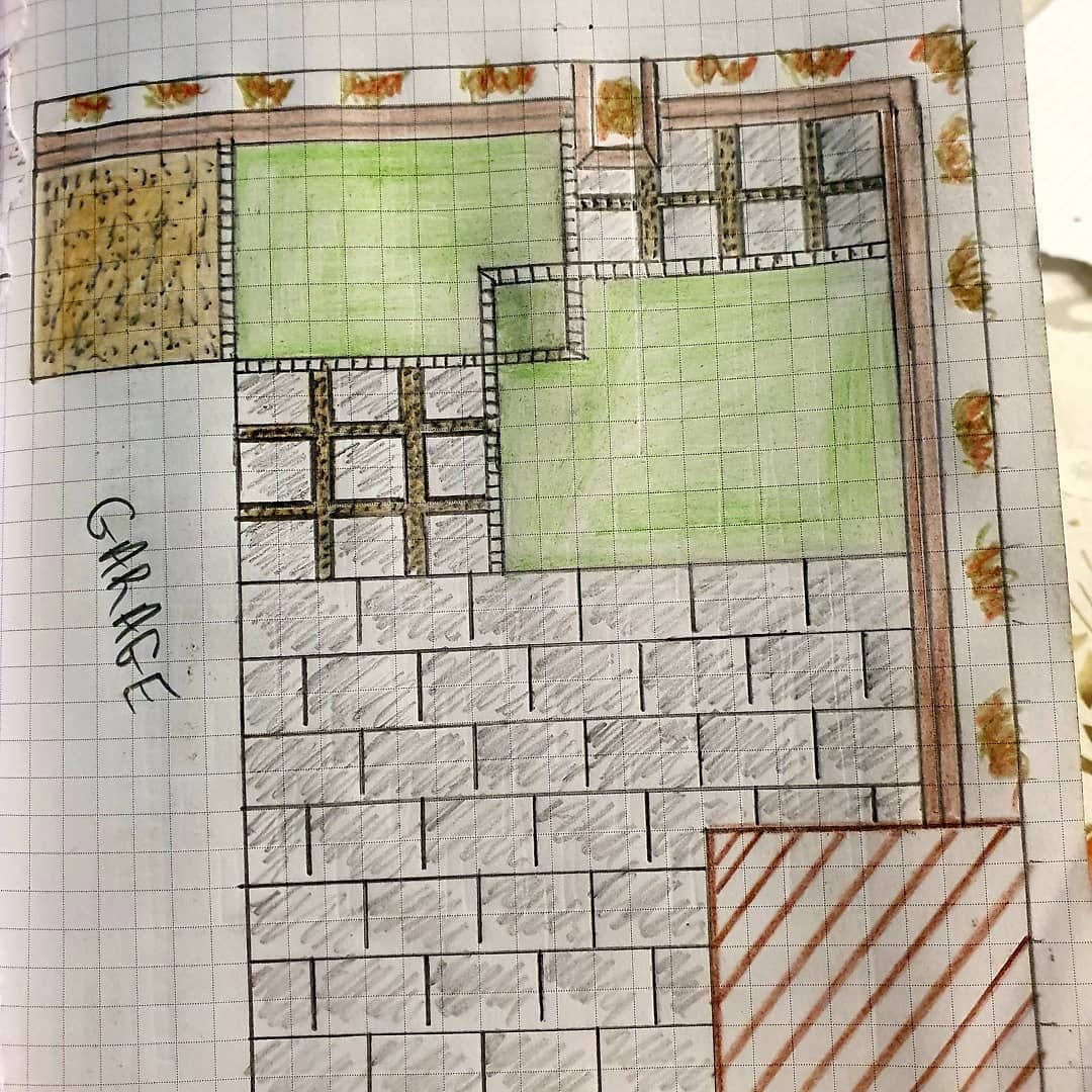 A hand-drawn garden plan on squared paper: two lawns coloured green, hatched grey paving, gravel paths in a grid, a brown border of shrubs and the word Garage written down the side.